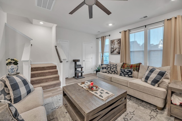 living room featuring light hardwood / wood-style floors and ceiling fan