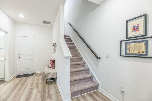 stairway featuring hardwood / wood-style floors