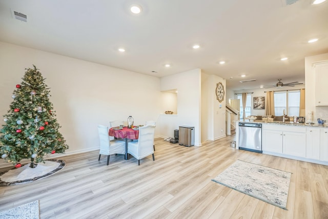 kitchen with dishwasher, white cabinets, and light hardwood / wood-style flooring