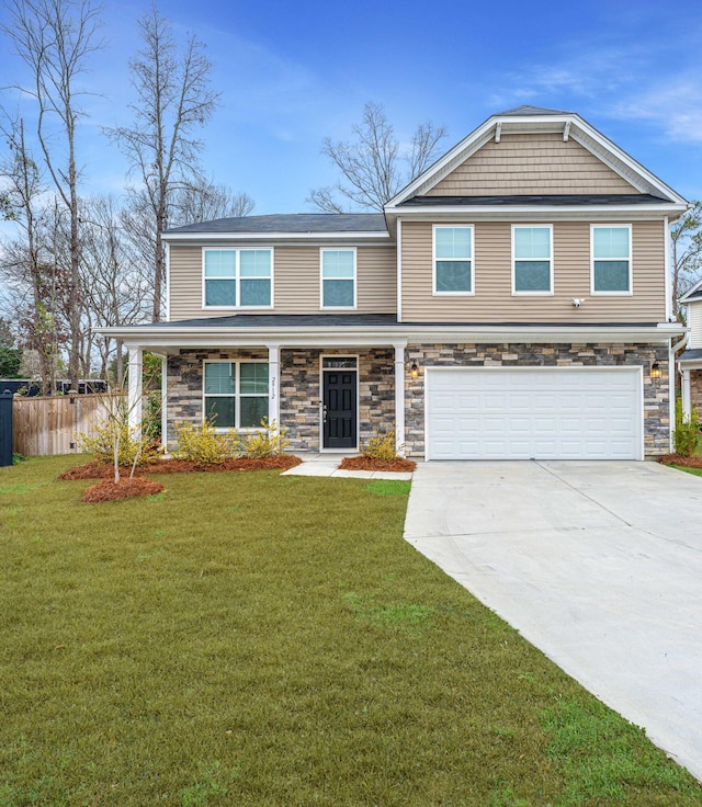 view of front facade with a garage, a front yard, and covered porch