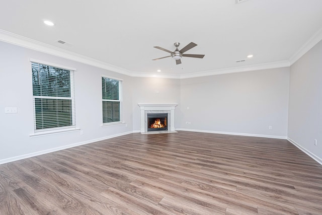 unfurnished living room featuring crown molding, ceiling fan, and light hardwood / wood-style flooring