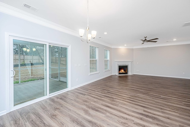 unfurnished living room featuring crown molding, hardwood / wood-style flooring, and ceiling fan with notable chandelier