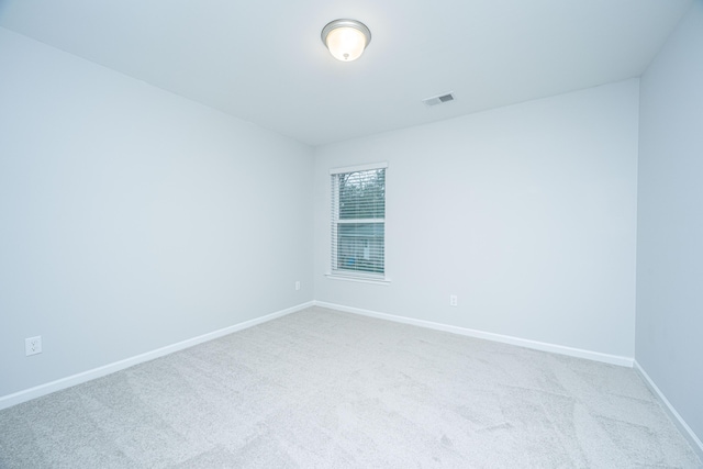 empty room featuring light carpet