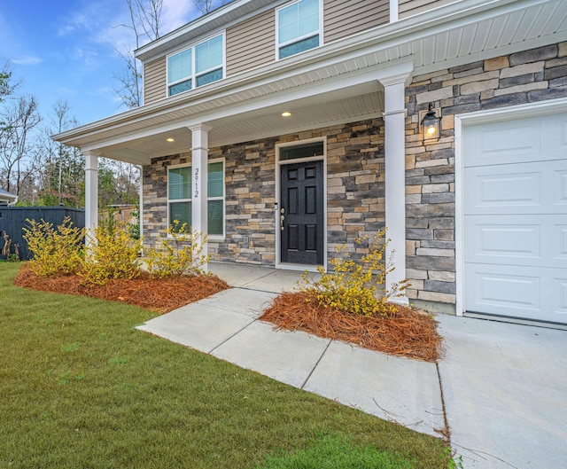 property entrance with a lawn and covered porch