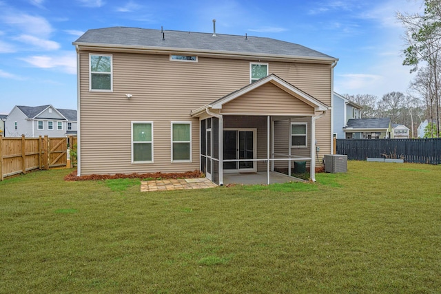 rear view of house featuring central AC, a patio, a yard, and a sunroom