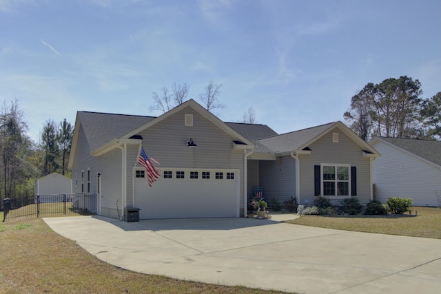 ranch-style home featuring a garage, fence, concrete driveway, and a gate