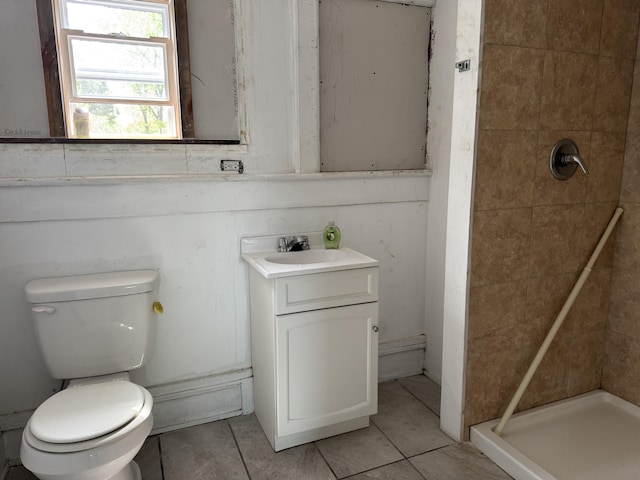bathroom with vanity, toilet, tile patterned flooring, and a stall shower