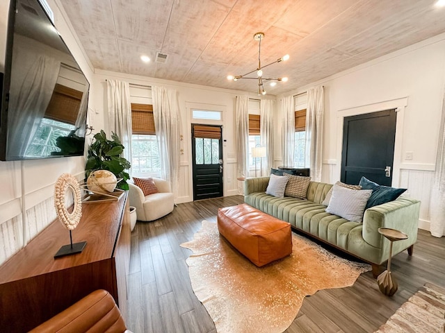 living room with dark hardwood / wood-style flooring and a chandelier