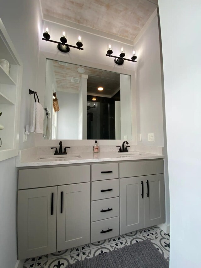 bathroom with tile patterned flooring and vanity