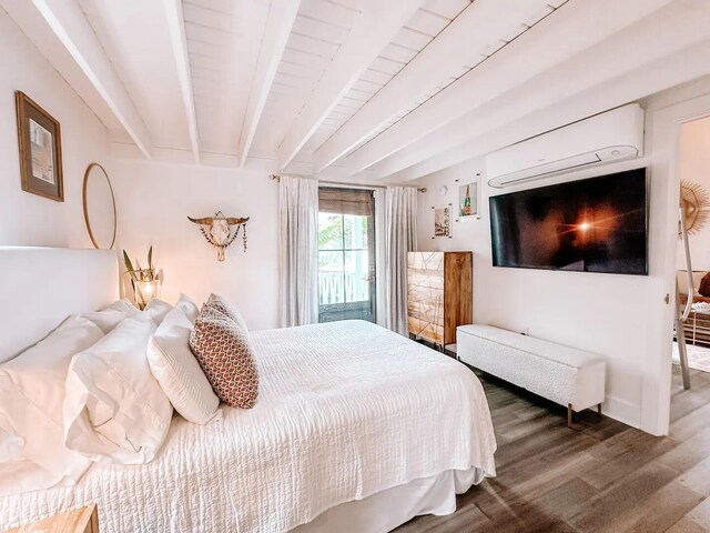 bedroom featuring beam ceiling, hardwood / wood-style flooring, and an AC wall unit