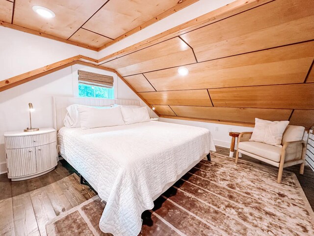 bedroom with wooden ceiling, vaulted ceiling, and hardwood / wood-style flooring