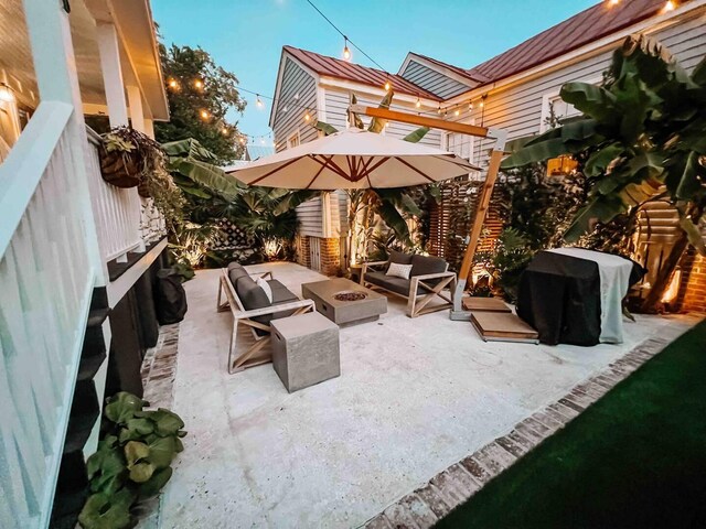 view of patio featuring a grill and an outdoor living space with a fire pit