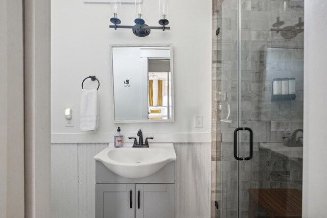 bathroom with an enclosed shower and vanity