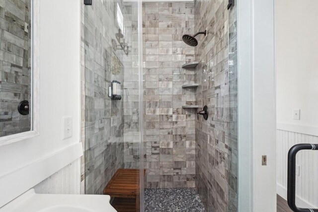 bathroom with a shower with shower door