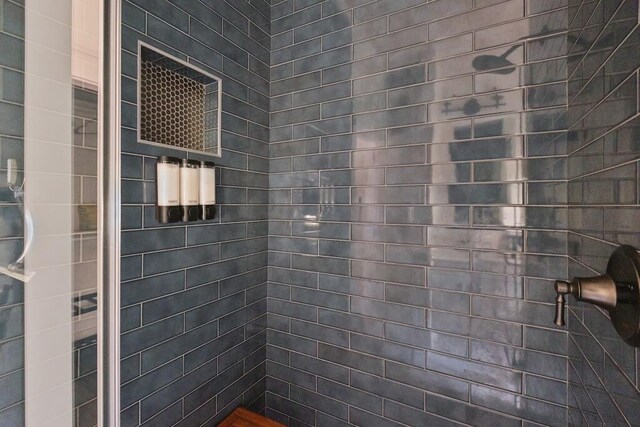 bathroom with a tile shower