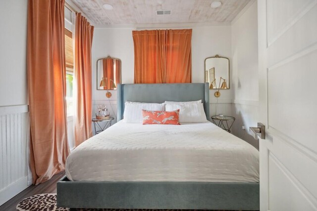 bedroom featuring dark hardwood / wood-style flooring and radiator heating unit