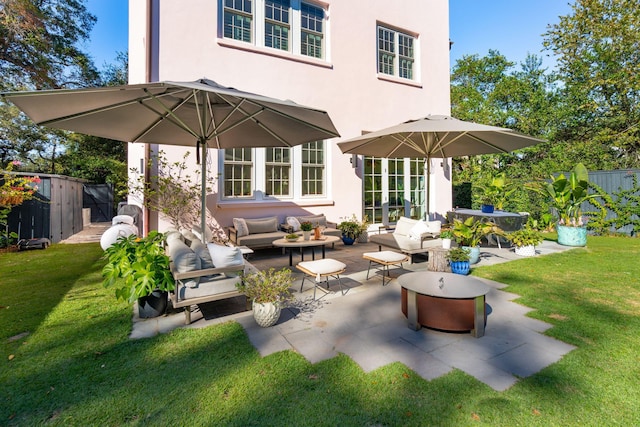 rear view of property with french doors, an outdoor hangout area, a patio, and a lawn