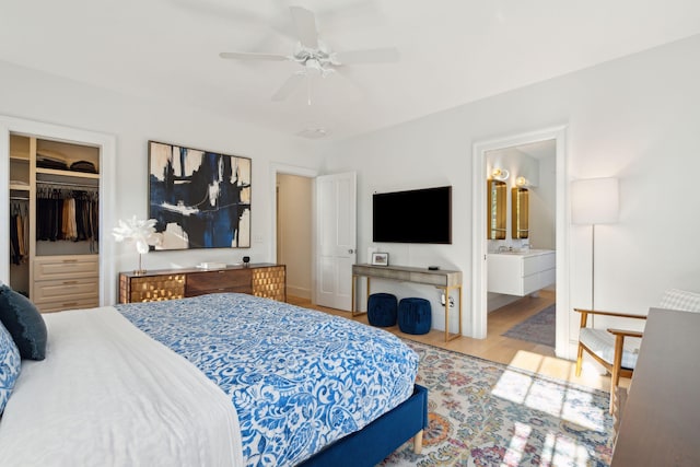 bedroom featuring ensuite bathroom, light hardwood / wood-style flooring, a closet, and ceiling fan