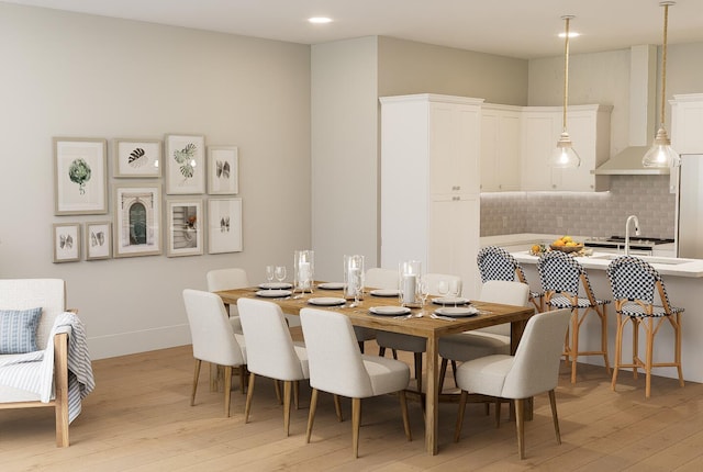 dining space featuring sink and light hardwood / wood-style flooring