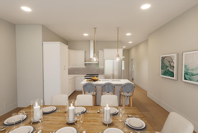 dining room featuring light hardwood / wood-style flooring and sink