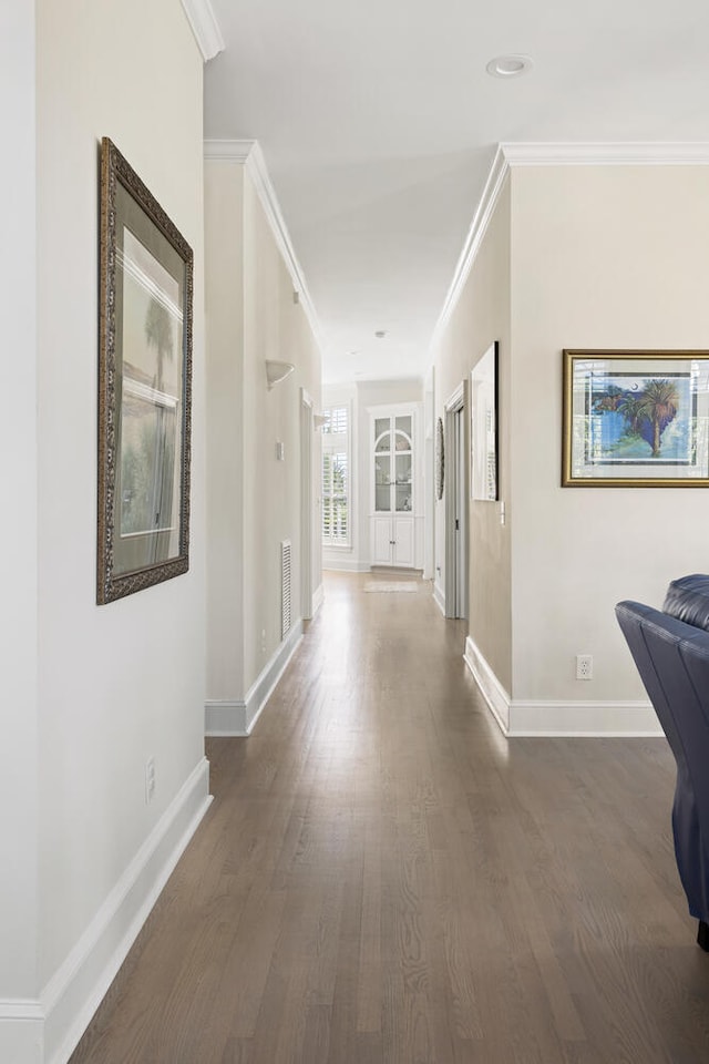 corridor featuring dark hardwood / wood-style flooring and crown molding