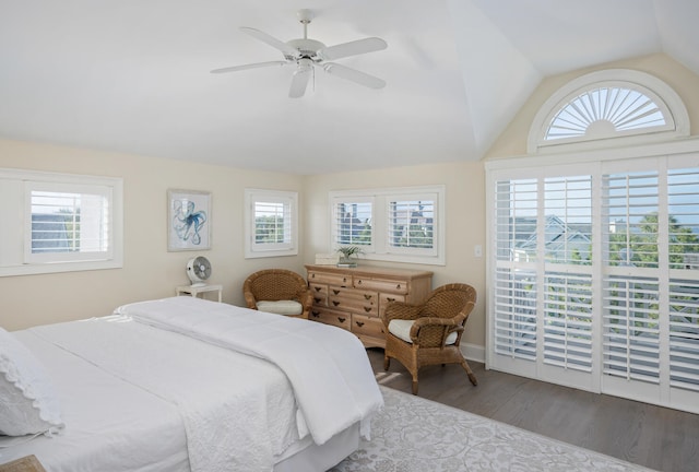 bedroom featuring ceiling fan, hardwood / wood-style floors, vaulted ceiling, and multiple windows