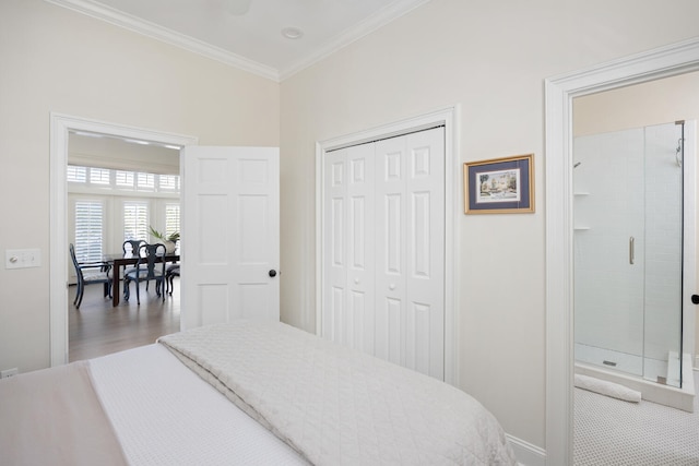 bedroom featuring a closet, hardwood / wood-style flooring, and crown molding