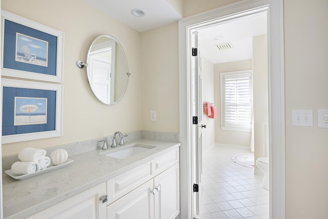 bathroom featuring vanity, toilet, and tile patterned flooring