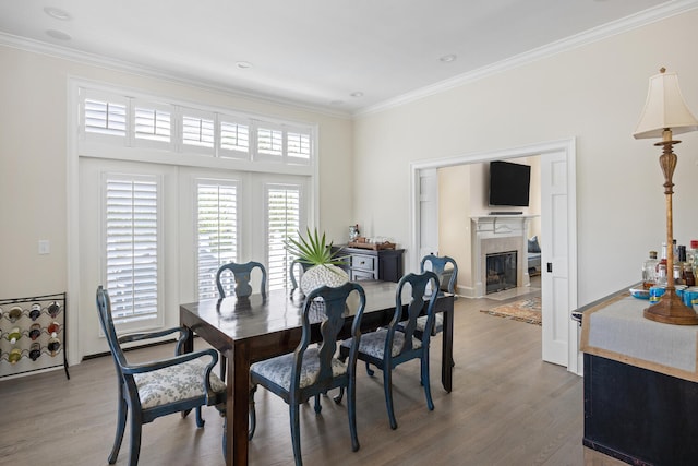 dining room featuring hardwood / wood-style floors and ornamental molding