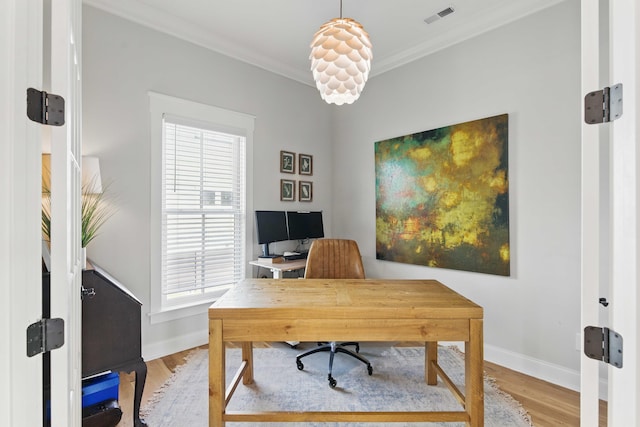 office area featuring crown molding, baseboards, visible vents, and plenty of natural light