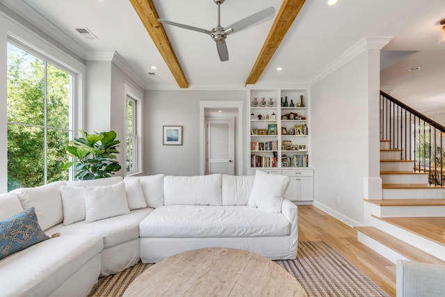 living area with stairs, visible vents, a wealth of natural light, and light wood-style flooring