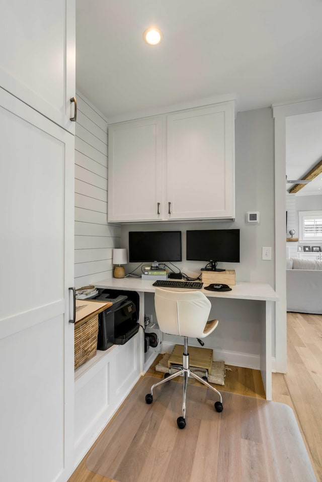 office featuring light wood-type flooring, recessed lighting, and built in desk