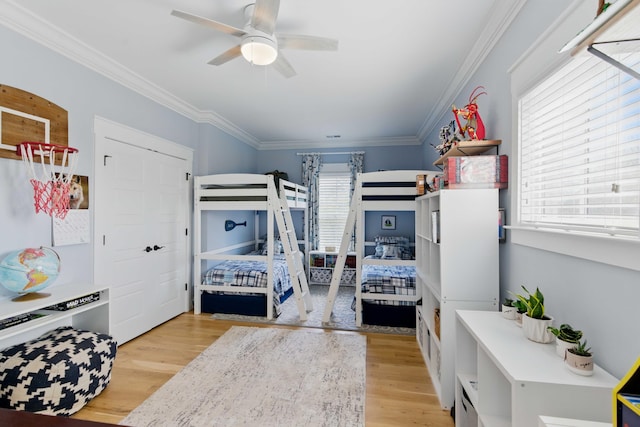 bedroom featuring ornamental molding, ceiling fan, and wood finished floors