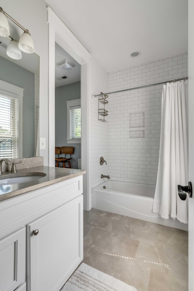 full bathroom featuring vanity, visible vents, and shower / tub combo
