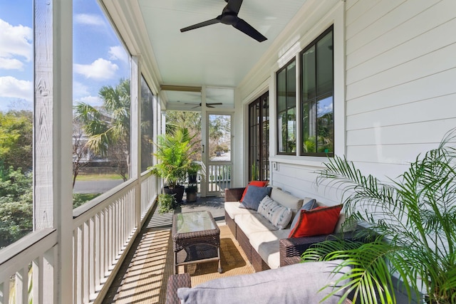 sunroom / solarium with a healthy amount of sunlight, ceiling fan, and outdoor lounge area