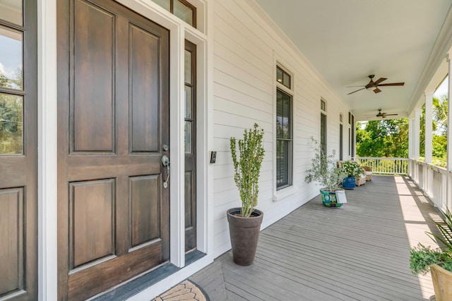 entrance to property with a ceiling fan and covered porch