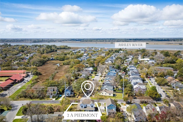 drone / aerial view featuring a residential view and a water view