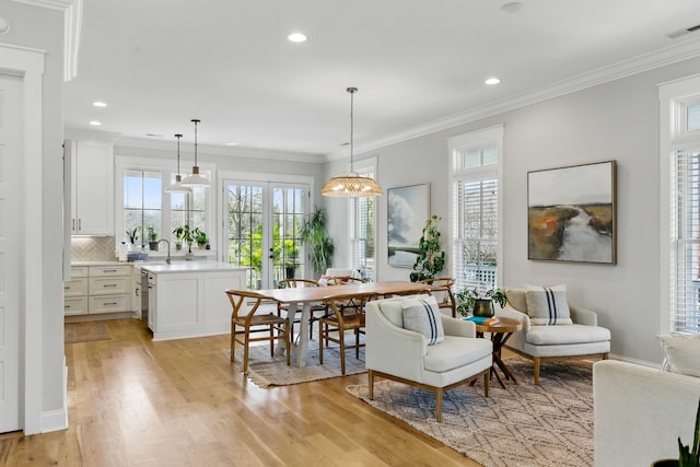 dining space with visible vents, ornamental molding, light wood finished floors, and recessed lighting