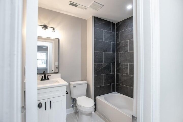 full bathroom featuring tiled shower / bath, vanity, and toilet