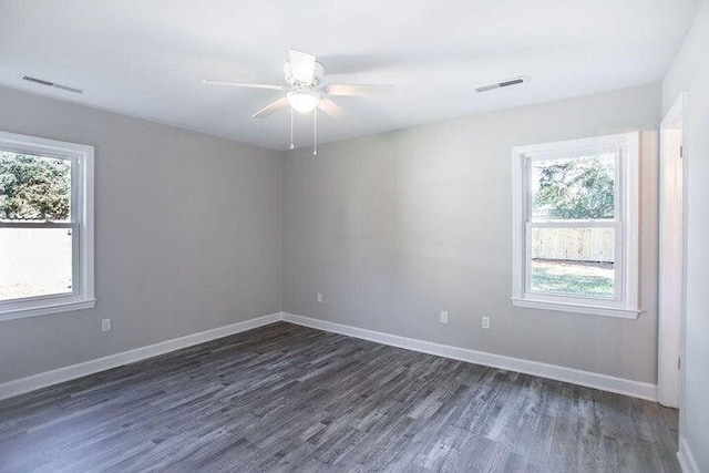 unfurnished room with dark hardwood / wood-style flooring, plenty of natural light, and ceiling fan