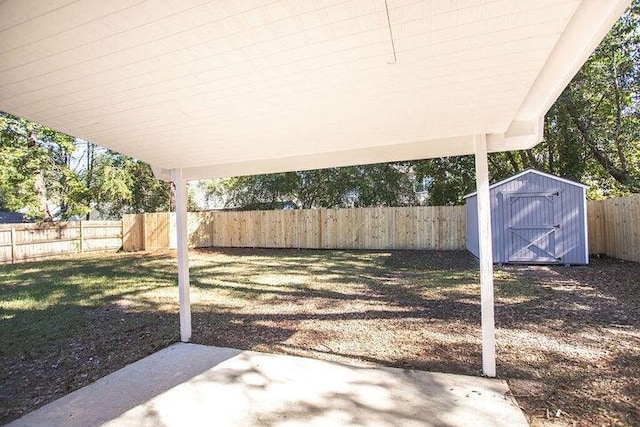 view of yard with a patio and a shed