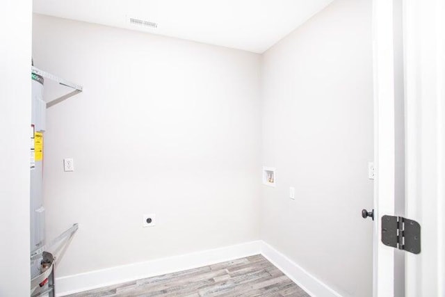 laundry area with electric dryer hookup, washer hookup, and light wood-type flooring