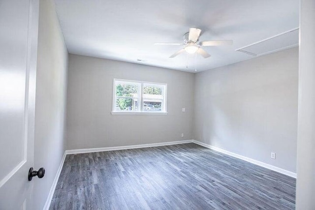 spare room featuring ceiling fan and dark hardwood / wood-style flooring