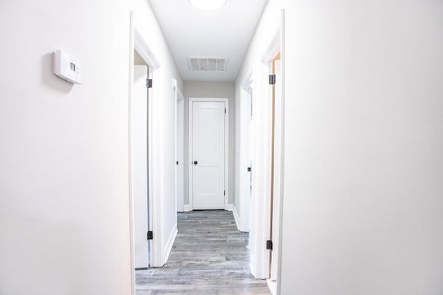 corridor featuring light hardwood / wood-style floors