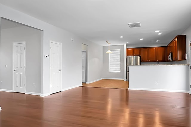 unfurnished living room featuring hardwood / wood-style floors