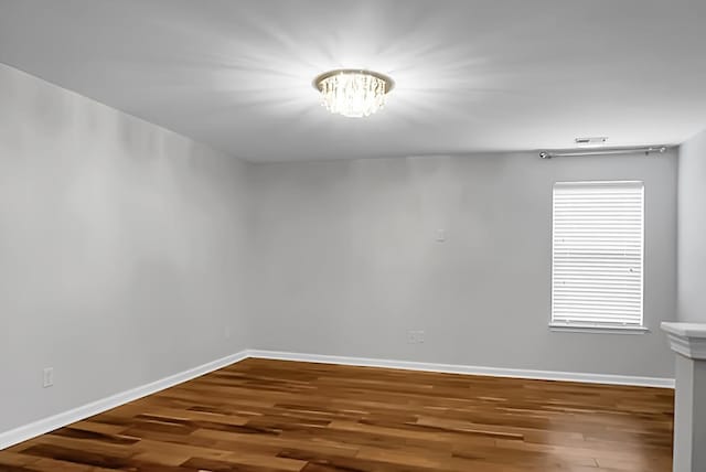 unfurnished room with hardwood / wood-style floors