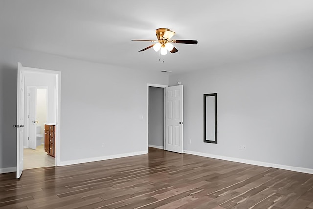 spare room featuring dark wood-type flooring and ceiling fan