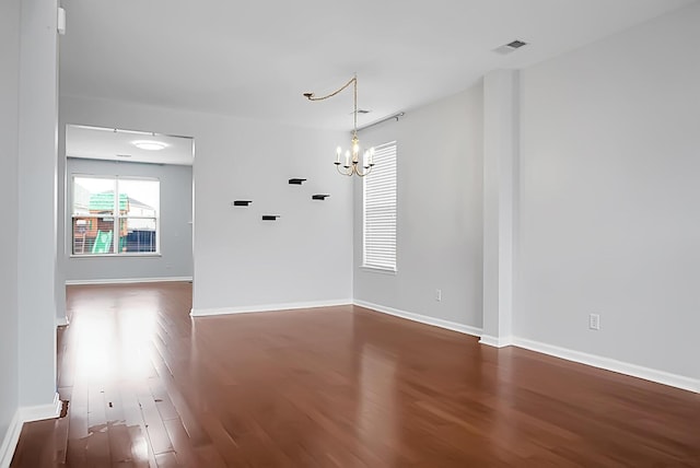 interior space featuring dark hardwood / wood-style floors and a chandelier