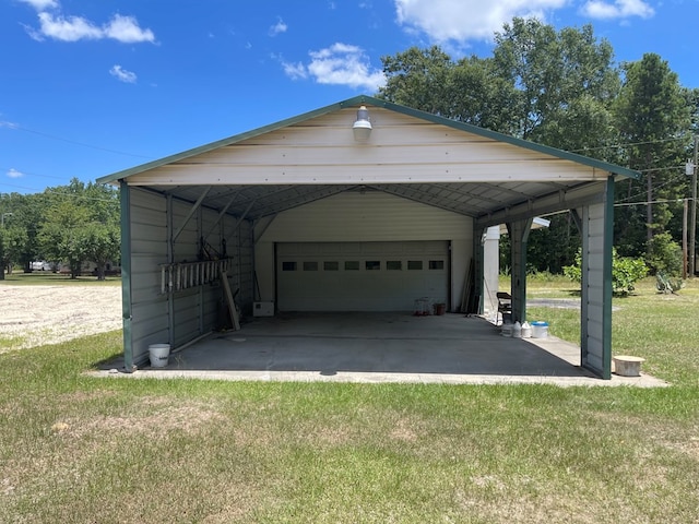 garage featuring a yard and a carport