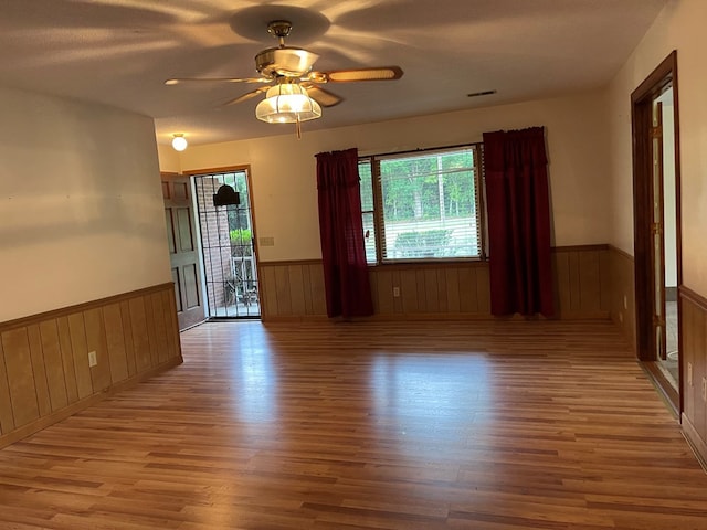 spare room featuring a textured ceiling, ceiling fan, and light hardwood / wood-style flooring